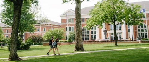 Students walking on the 鶹ƵAPP campus in front of Crounce Hall